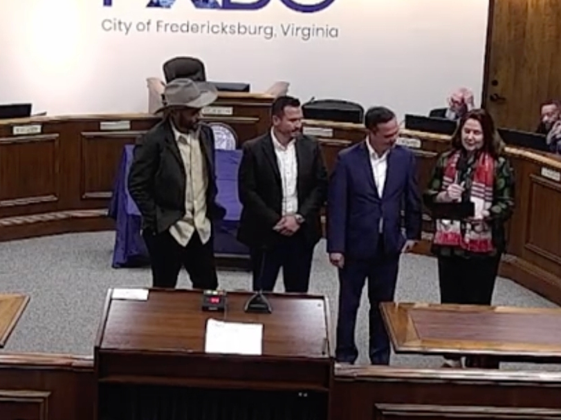 Mayor Kerry Devine (right) presents a proclamation to representatives of the Fredericksburg City Soccer Club declaring Wednesday as Fred City Soccer Club Day.