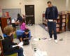 New York Yankees General Manager Aaron Boone demonstrates science and technology students to Summit fifth graders, using toy Hess trucks.