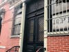 A side view of the historic corner drug store in Hoboken at 1000 Washington St., with its pharmacy ghost sign.