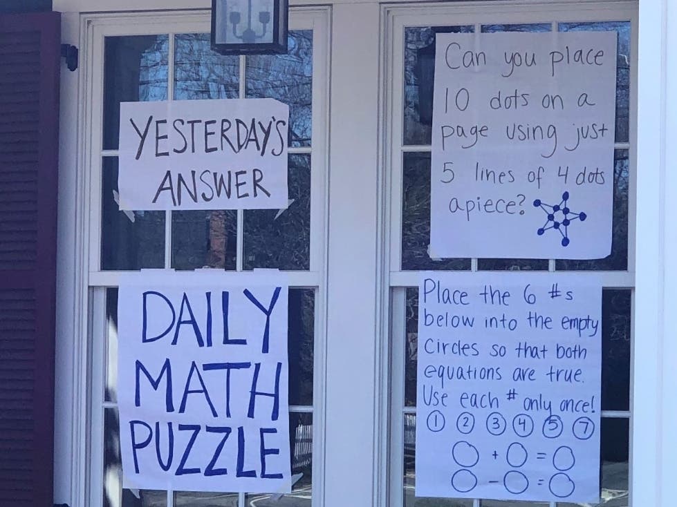 Westfield High School math teacher Callie Campbell posts a daily math joke and puzzle in the front windows of her Westfield home for passersby.
