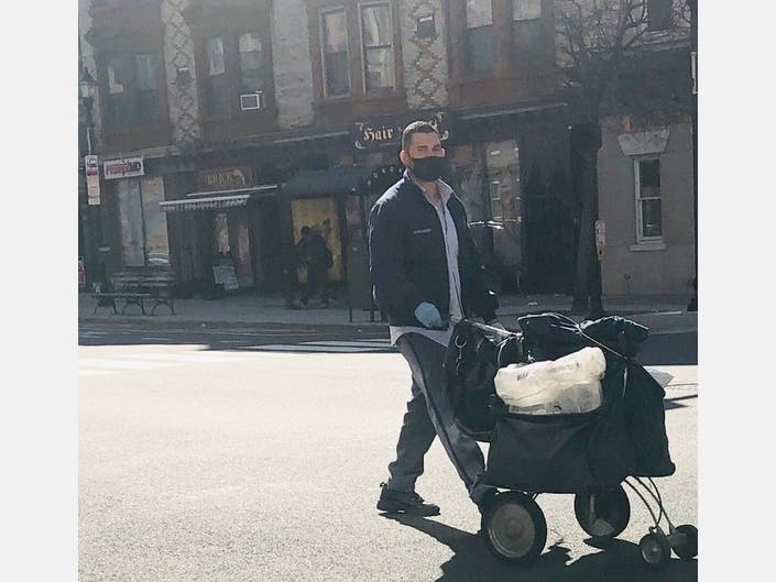 A mailman wears a mask and gloves in Hoboken last month. The CDC advised this week wearing some kind of face covering to prevent the spread of coronavirus.