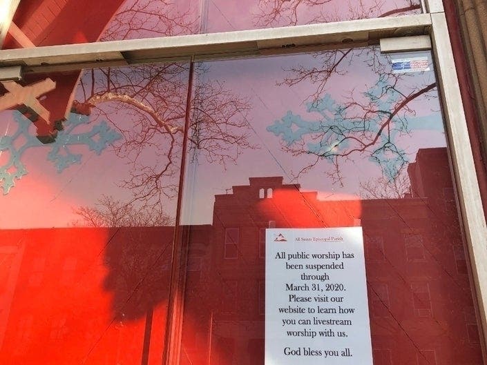 A sign on All Saints Parish in Hoboken, NJ in March, when people weren't sure how long coronavirus restrictions would last. Gov. Murphy now says people can gather for services in their cars.