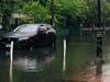 A man looks out of his stuck car in Hoboken during Tropical Storm Fay in early July. The local sewer authority said the storm was the equivalent of a "50-year" storm -- but then another 50-year storm came two weeks later.