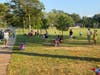 People head to the park to listen to a free concert.