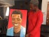 Maplewood resident Hawa Fofana holds a painting of her slain son Moussa, created by a friend. At a rally held Wednesday night, friends remembered the teen, an aspiring soccer star.