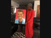 Moussa Fofana's mother, with a painting of him created by a friend.
