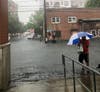 A man walks to the Hoboken ShopRite Thursday evening as the area suddenly became flooded in advance of Tropical Storm Elsa.