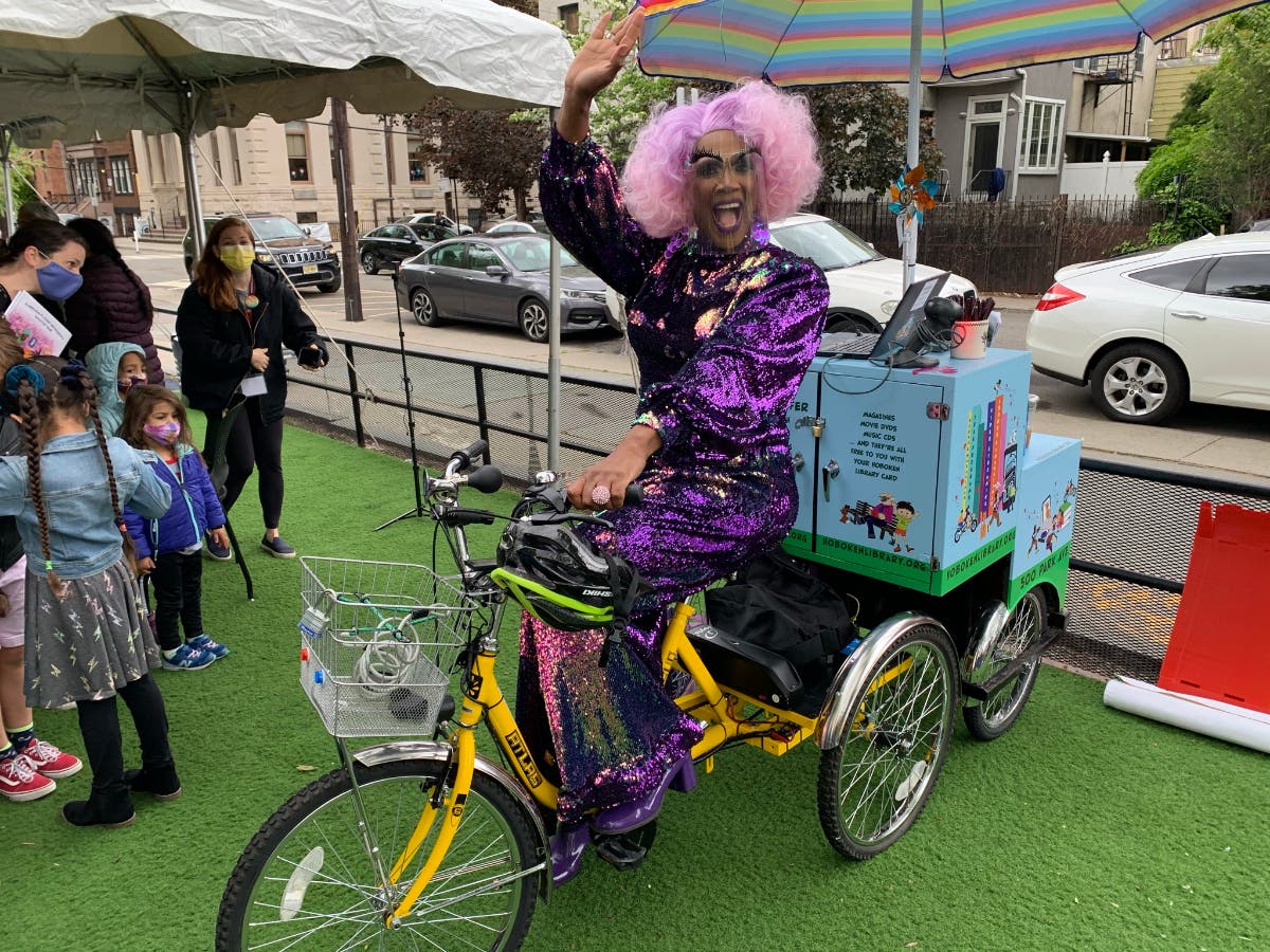 A colorful Harmonica Sunbeam reads to kids at the Hoboken Library in June.