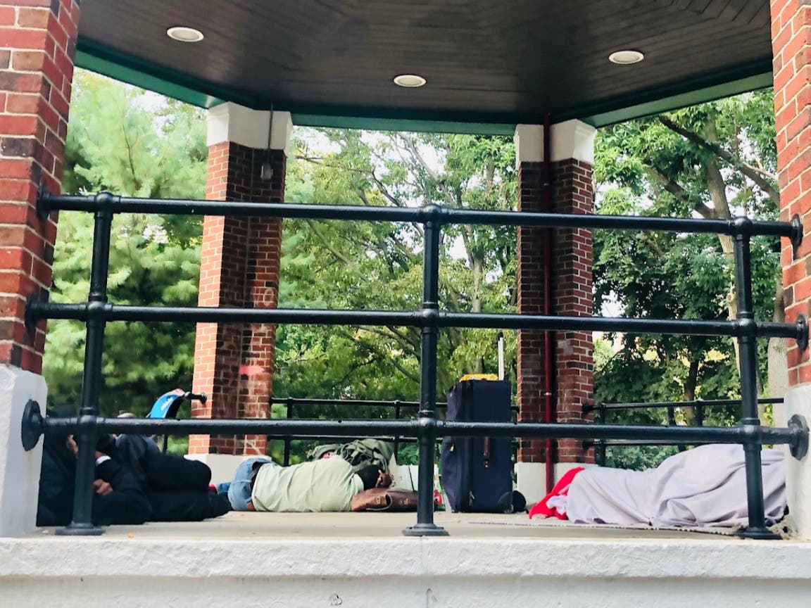 Homeless Hoboken residents resting at a local park on Sunday morning.