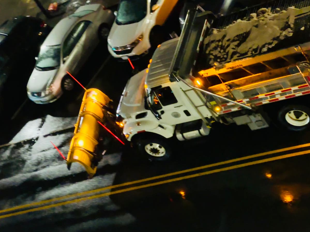A salt truck moves through Hoboken Saturday evening.