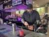 Bar manager Juan Arboleda prepares fresh pomegranites for a new summer cocktail. (He's facing the public side of the bar. Behind him, residents of 3 Acres have their own special side they can access.)