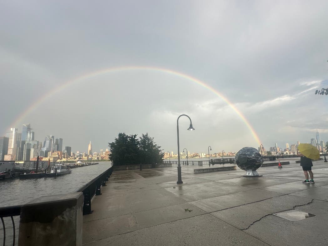 Pedestrians on the Hoboken waterfront took photos of a rainbow over Manhattan once the storm cleared.