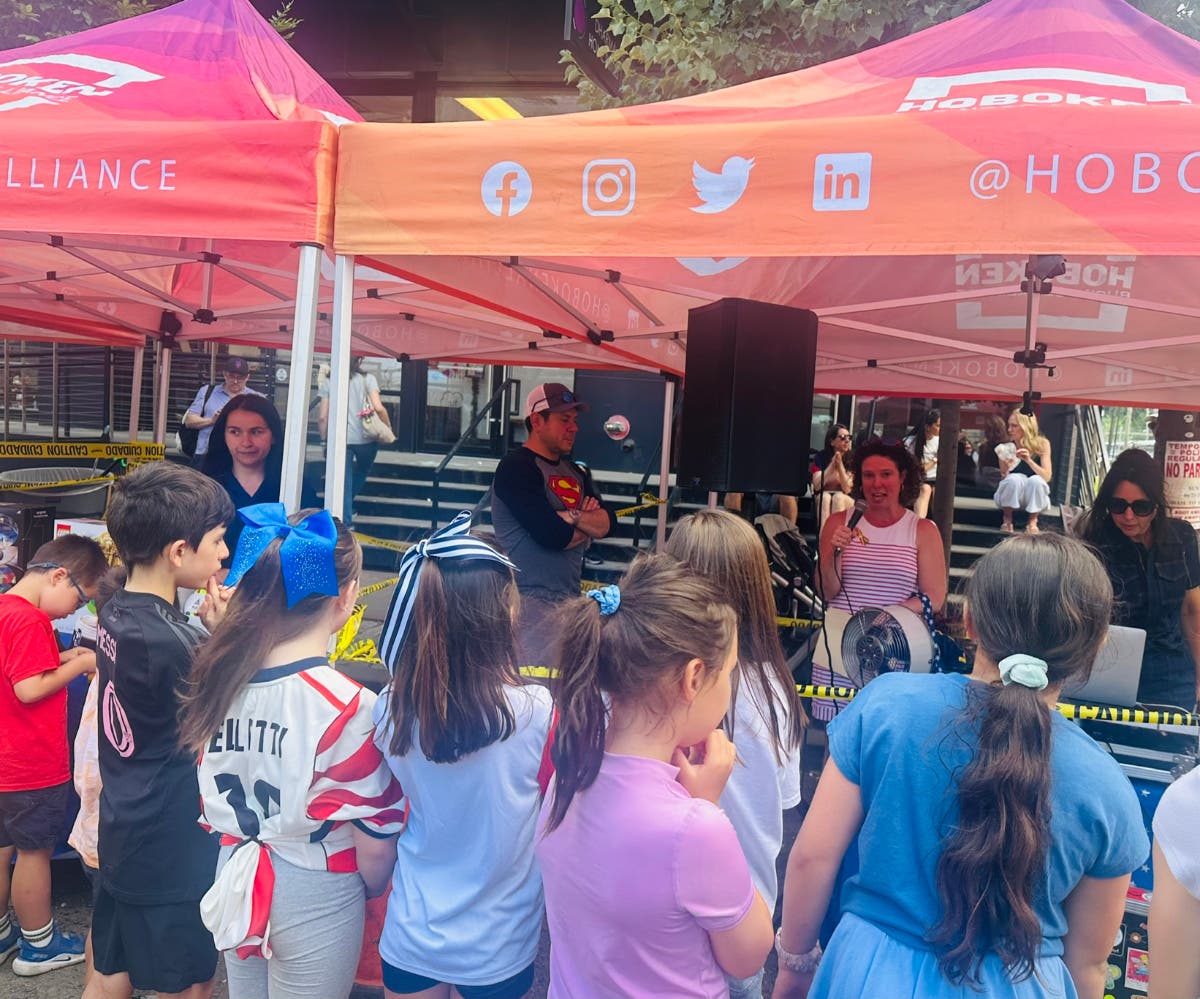 Children waited at a Big Match Block Party event in Hoboken on Friday to find out which four kids would win a lottery for World Cup tickets.