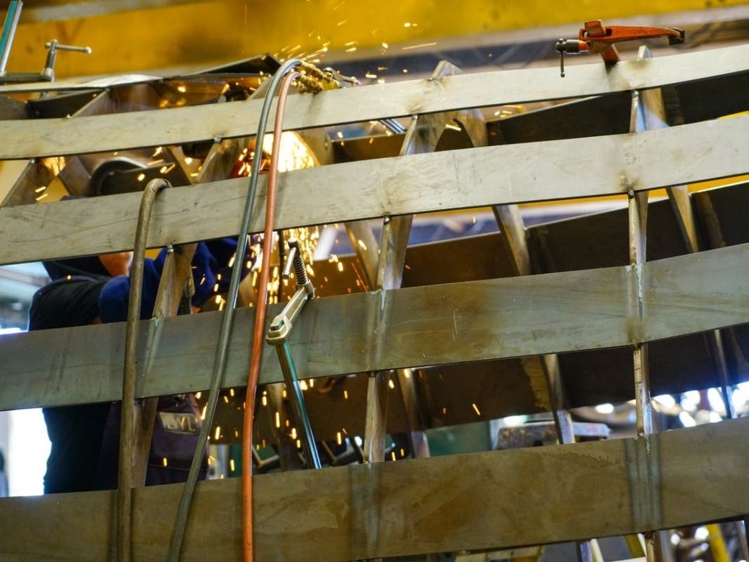 BELLY OF THE BEAST -- Sculptors are still at work on the steel whale. It will be finished by fall.