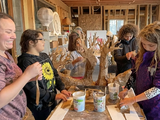 Volunteers participate in a puppet-making workshop with Processional Arts Workshop. 