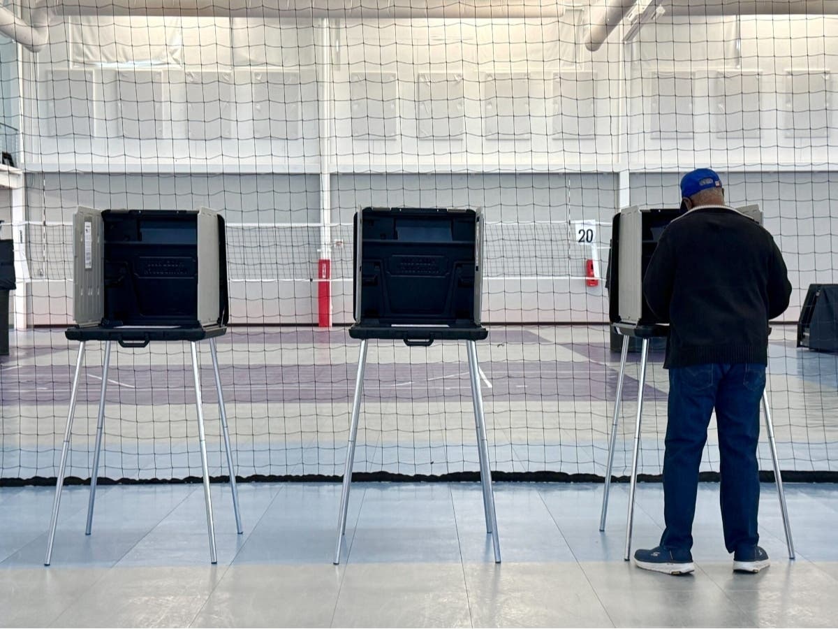 A voter casts a ballot in the April 21 redistricting referendum at the Stonebridge Recreational Center in Chesterfield County. 
