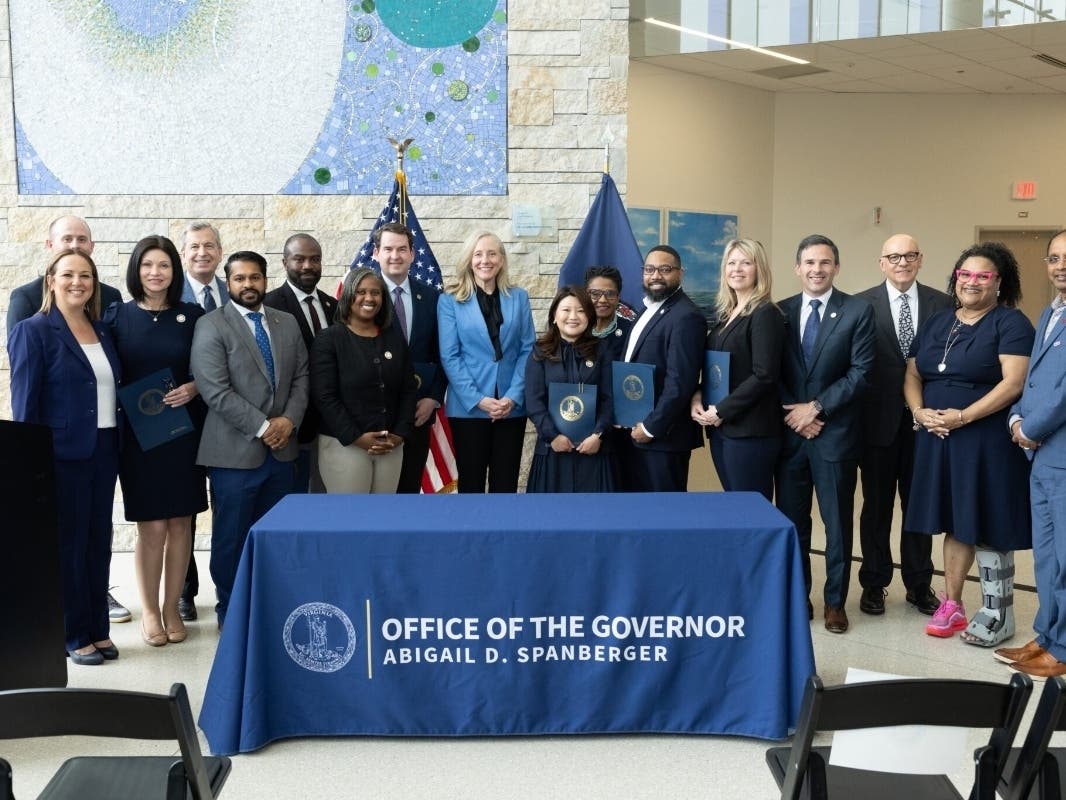 Gov. Abigail Spanberger stands with Virginia healthcare leaders and lawmakers after signing a slate of bills to bring down medical care costs in Fairfax on May 13, 2026. 