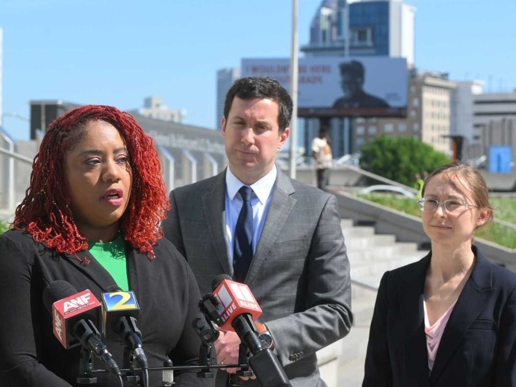 Cathy George and Institute for Justice attorneys Marie Miller and John Korevec speak outside a federal courthouse in Atlanta about their lawsuit stemming from a botched raid of George’s Sandy Springs home in 2023. 