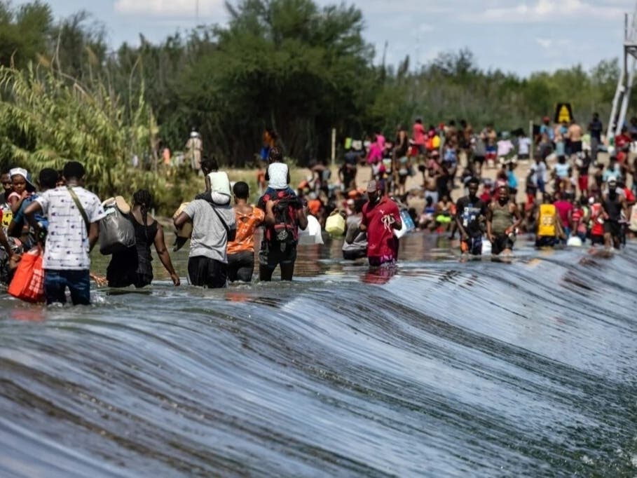 Migrants, many fleeing violence in Haiti, cross the Rio Grande at Del Rio, Texas, in 2021 to buy supplies in Mexico while waiting to claim asylum in the United States. 