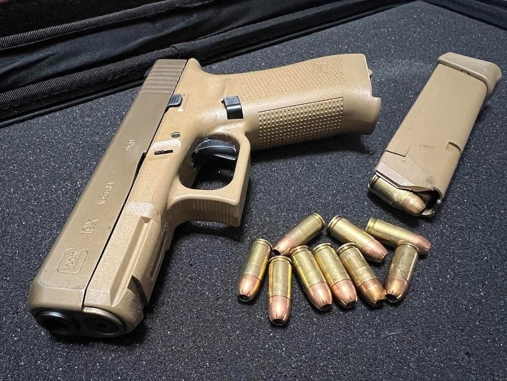 An unloaded Glock 19X handgun sits next to a magazine and 9 mm ammunition at a gun range. Several states have enacted laws that allow judges to temporarily remove guns from people in crisis, but a growing number of states are banning the measures.