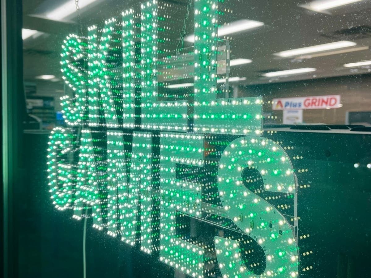 A sign in a convenience store window advertises skill games, slot machine-like devices.