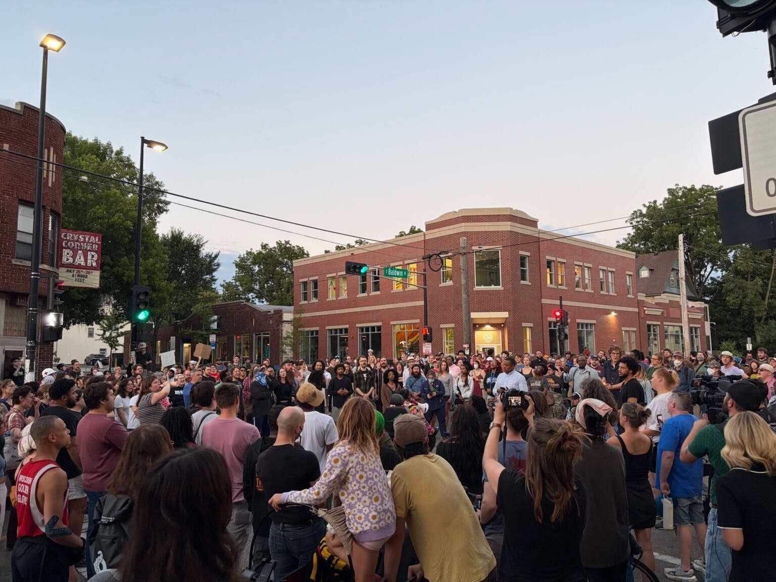 A crowd gathers on the corner of Williamson and Baldwin Streets Wednesday night to protest after police shot and killed Corey Ruiz