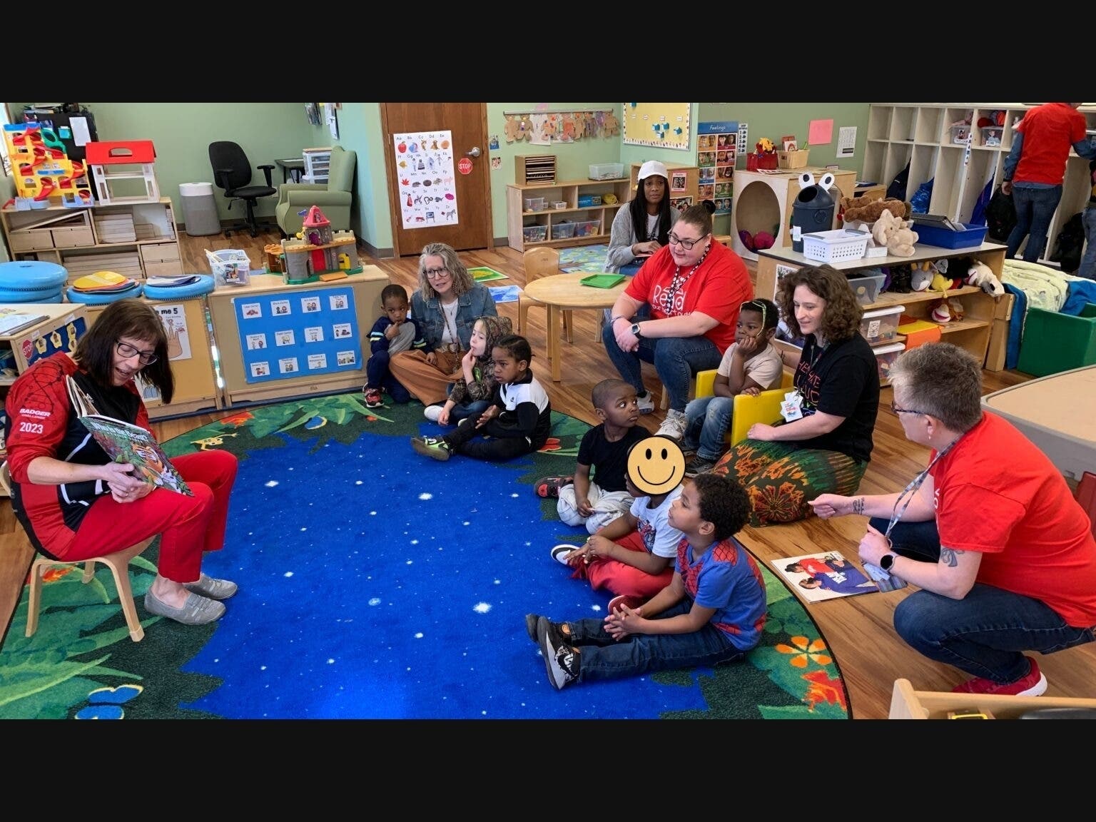 Children at a Sun Prairie Head Start center operated by Reach Dane gather in a circle with their teachers for a story.