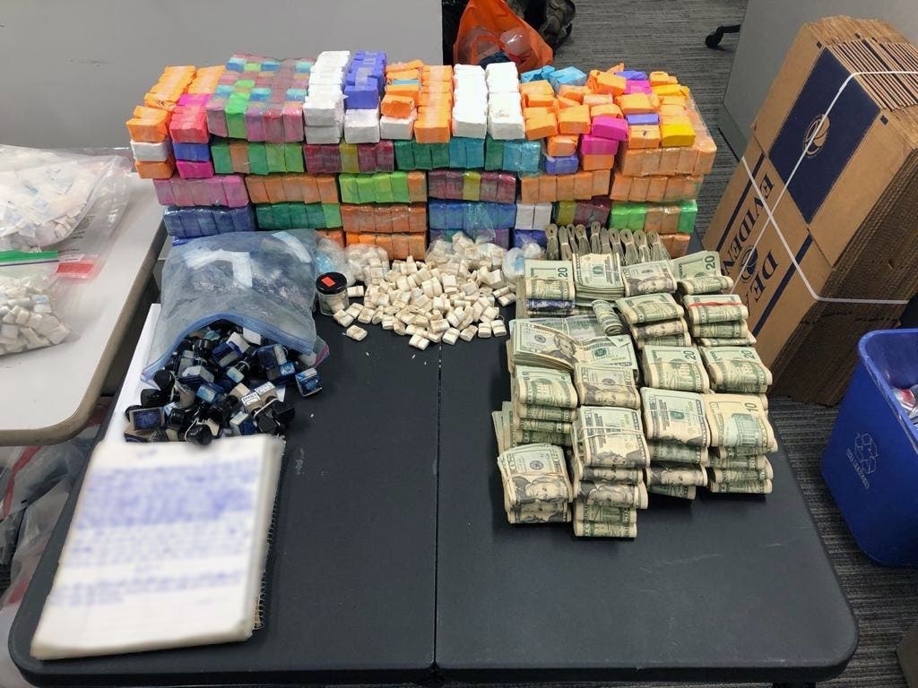 A photo showed packaged drugs and cash seized in large-scale bust conducted by authorities.
