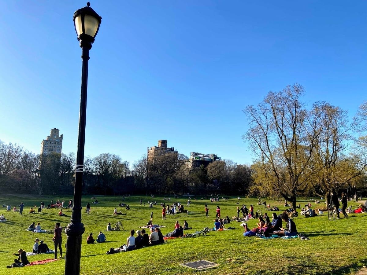 Crowds in Prospect Park enjoy an impromptu concert Thursday. A year ago, the park stayed largely empty amid the first wave of coronavirus.