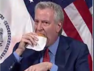 Through a mouthful of burger, Mayor Bill de Blasio told New Yorkers they can get free Shake Shack if they get — or got — the COVID vaccine.