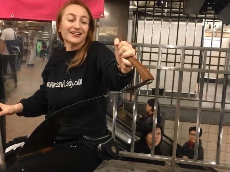 Natalia "Saw Lady" Paruz plays the saw at Herald Square, where she'll be Friday for the first time in 14 months.