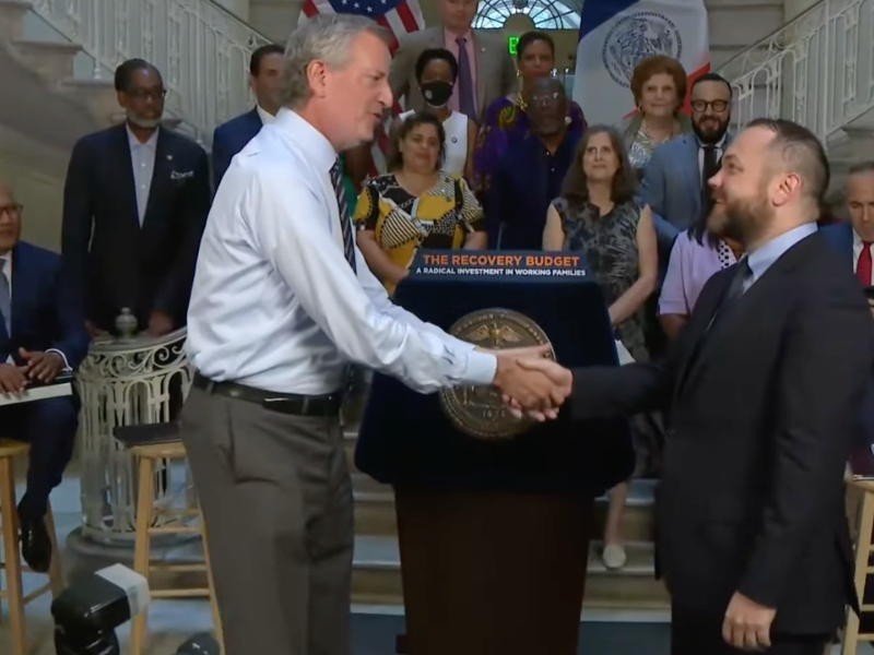 Mayor Bill de Blasio and Council Speaker Corey Johnson on Wednesday shake hands on a $98.7 billion 2022 budget.