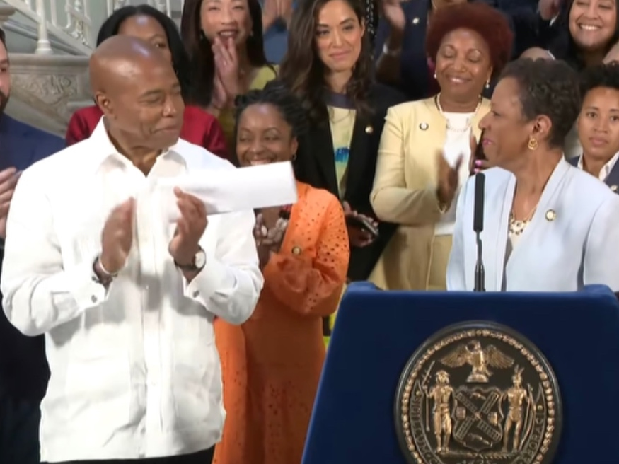 Mayor Eric Adams, left, Council Speaker Adrienne Adams and Council members celebrate a $101 billion 2023 budget deal Friday.