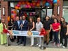 Mayor Sharon Ashe-Nadrowski and members of the Bayonne City Council join owners and staff members of Haven House to cut the ribbon on the new restaurant.