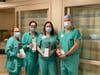 Nursing Staff at Northwestern Medicine Central DuPage Hospital hold their gifted roses. 