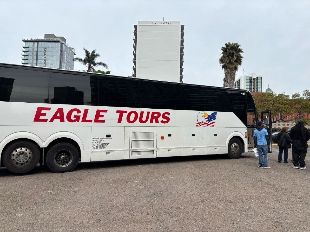 People getting on an Eagle Tours bus on Wednesday, Jan. 28, 2026, near City Hall. / 