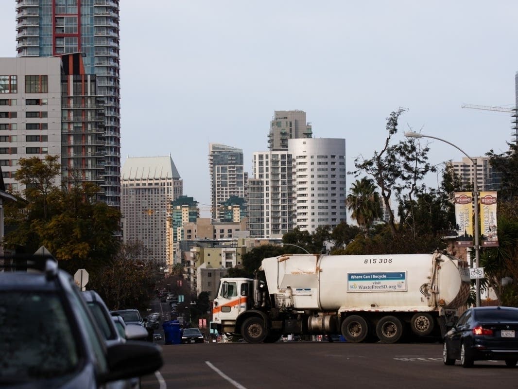 A garbage truck goes through a route in the Sherman Heights neighborhood on Jan. 11, 2023. 
