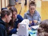 Young women learning too are as they make Teddy bears for refugee children. 
