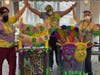 Staff members Odanny Espinal, Daniel Gonzalez and Michelle Manygoats display their Mardi Gras 'floats.'