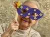 Resident Loretta Pennock shows off her Mardi Gras mask. 