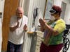 Resident Alfonso Posada dances along with staff member Odanny Espinal.