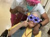 Maria Reyes enjoys the music with Marvalee (staff).