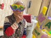 Resident Lien Phung wears her Mardi Gras mask.