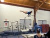 On bars, Alex Decsi does her best for the team.
