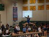 Olivia Perkins leaps into a split on beam.