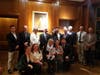 The Anderson Family gathered for a photo in the library under a portrait of Janet Lance Anderson.