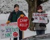 Protesters gathered for two hours, holding signs, speaking over bullhorns, and cheering as vehicles honked their horns on Baboosic Road.