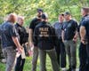 Law enforcement spent most of Wednesday at a residence on Flagg Road executing a search warrant and gathering items in evidence bags.