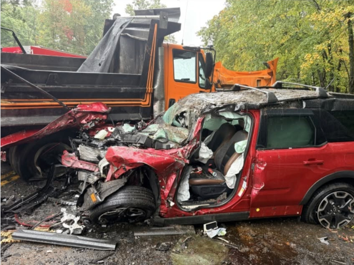 A violent head-on collision between a dump truck and a passenger vehicle sent two people to the hospital Monday afternoon