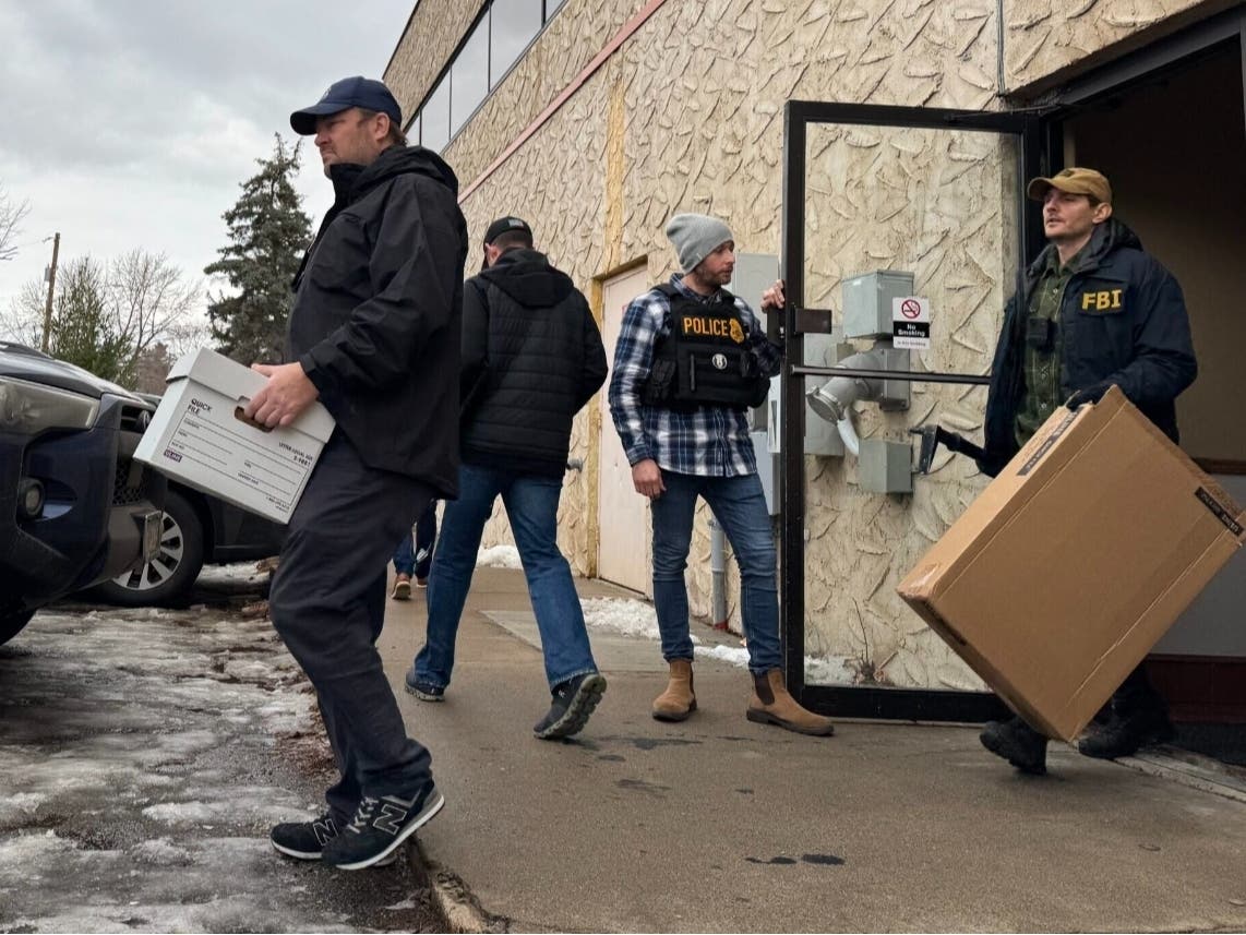 Federal agents load evidence into vans after raiding the office of Ultimate Home Health Services in Bloomington on Thursday, Dec. 18, 2025. 